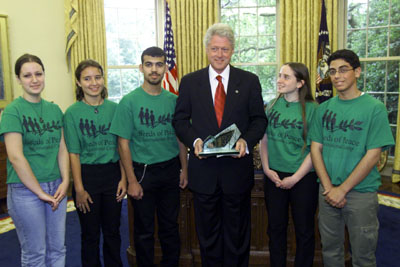 President Clinton receives the Seeds of Peace Award, Oval Office. Pictured with the President are Manal Abbas, Dalia Ali, Jamil Zraiqat, Avagail Shaham, and Jawad Issa.